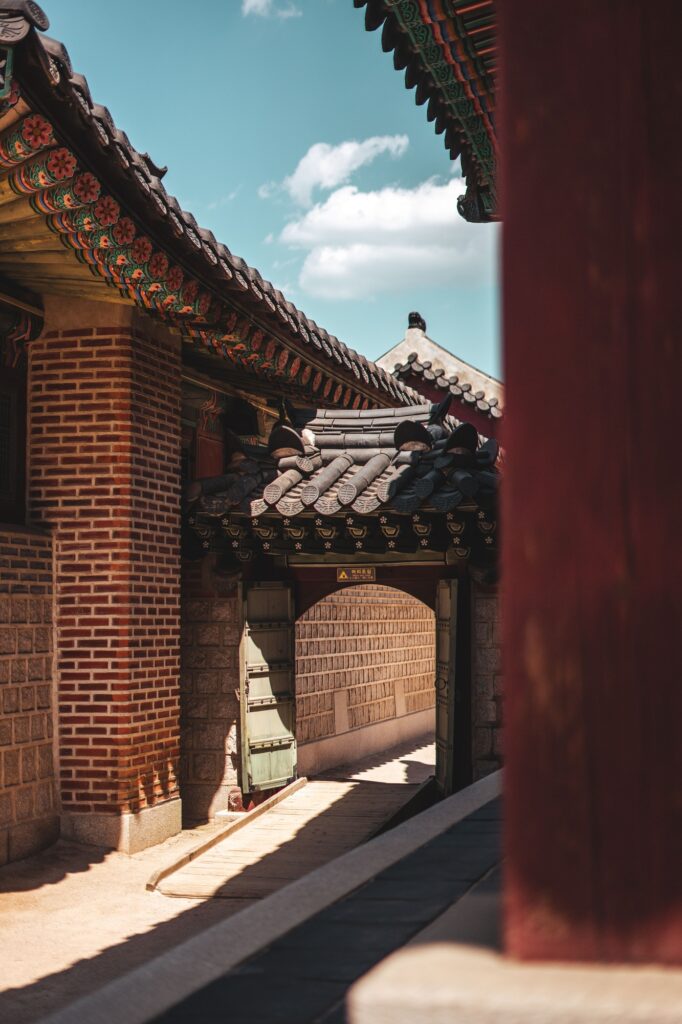 Vertical shot of a traditional Korean building under the sunlight and a blue sky